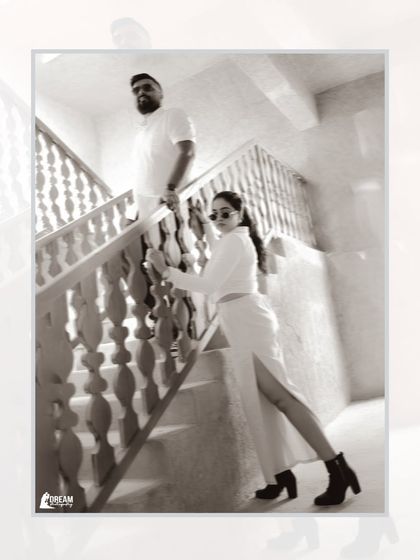 A fashionable, high-contrast black and white portrait on a staircase, showcasing a modern and edgy style for a couple's shoot in Dubai.