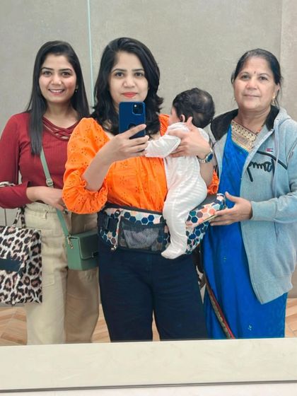 A mirror selfie with my sister, mom, and my little one in a Buttbaby carrier. Three generations of love in one frame.