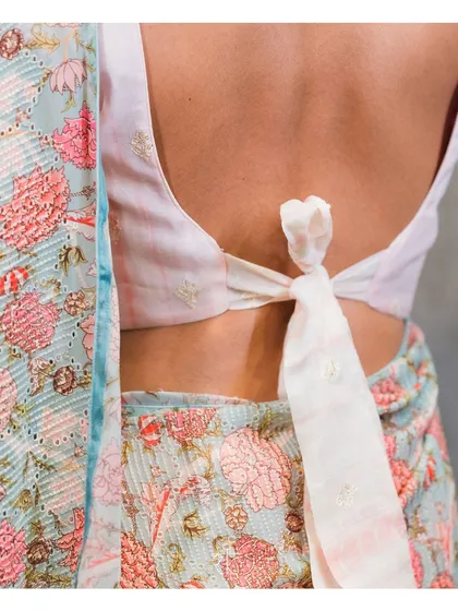 The back of the self-fabric blouse features a simple and elegant tie-back knot, keeping the look fresh and modern.
