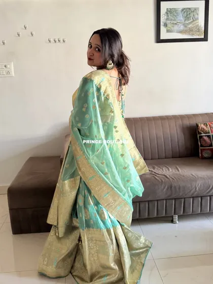 The back view of the Banarasi lehenga, showing the elegant drape of the dupatta and the stylish back of the blouse.
