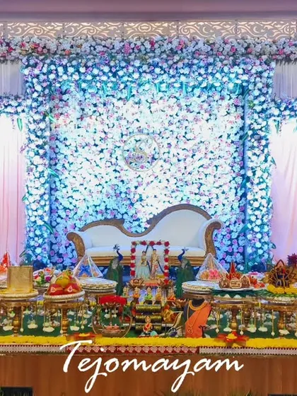 A beautiful engagement setup with a backdrop of blue and white flowers, creating a cool and elegant ambiance.