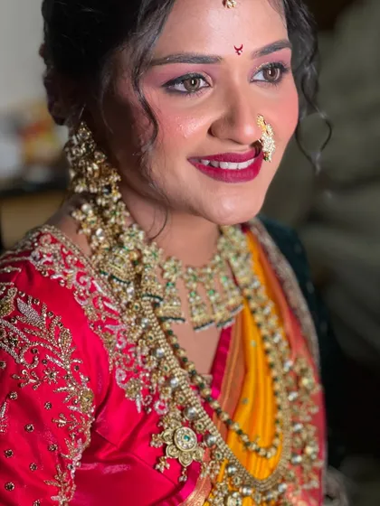Pooja's stunning bridal portrait, showcasing the heavy traditional jewellery and flawless makeup.