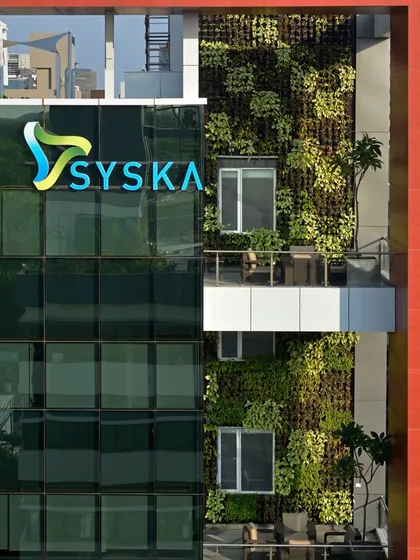 A close-up of the green wall on the Syska building, showing the density and texture of the vertical garden.