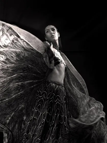 Black and white photography allows me to focus on form, emotion, and movement. This image captures a dancer mid-motion, the swirling fabric creating an abstract, wing-like shape that conveys a sense of freedom and artistic expression, ideal for a powerful editorial story.