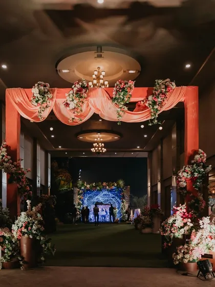 The elegant floral entrance to the Sangeet hall, creating a warm and welcoming first impression for guests.