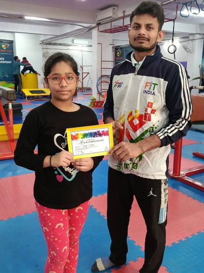 This student proudly displays the certificate she earned for her hard work.