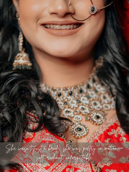 A close-up of the bride Paromita's radiant smile and intricate jewelry, with a poetic caption that beautifully describes her essence.