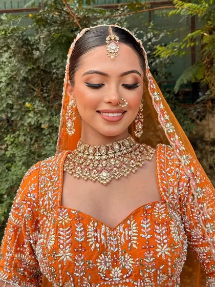 A serene moment with eyes closed, highlighting the soft, shimmery eyeshadow and the overall radiant finish of the makeup.