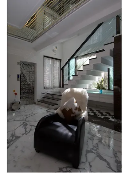A showcase of cozy seating areas created in transitional spaces like landings and hallways, featuring elegant chandeliers and comfortable chairs.