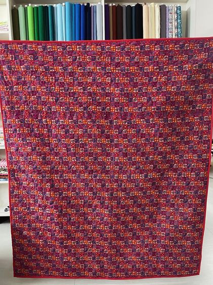 The colorful backing fabric of the scrappy quilt.