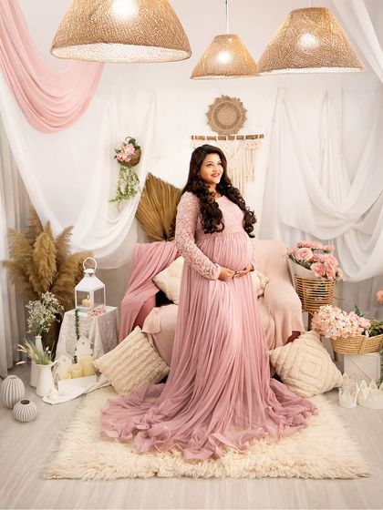 A vision in dusty pink. This full-length portrait showcases our romantic, pink-themed boho setup, complete with pampas grass, candles, and soft fabrics.
