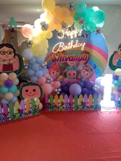 Another Cocomelon theme, this time with a rainbow backdrop and a cute picket fence. The pastel balloon colors make this a very cheerful setup for a little one's birthday.