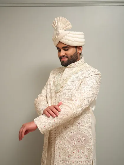 The complete royal groom look, featuring a beautifully tied turban and pearl necklace. My styling ensures that every element, from the makeup to the accessories, comes together perfectly.