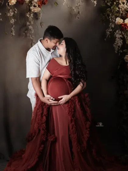 This dramatic, ruffled gown was perfect for a romantic couple's portrait. The deep red color and the couple's close embrace create a feeling of passion and anticipation.
