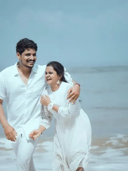 The pure, unscripted joy of a couple's walk on the beach. My goal is to capture these natural, candid moments of laughter that truly reflect your relationship.