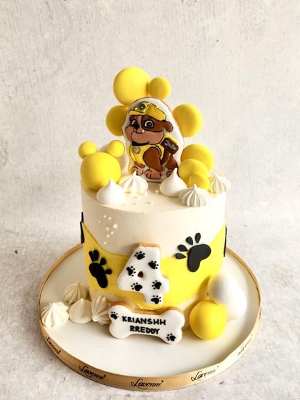 A Paw Patrol cake featuring Rubble for Krianshh's 4th birthday. The yellow theme with paw prints and dog bones is so much fun.