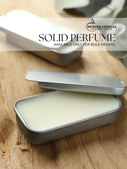 A close-up of the solid perfume, highlighting its smooth, balm-like texture.