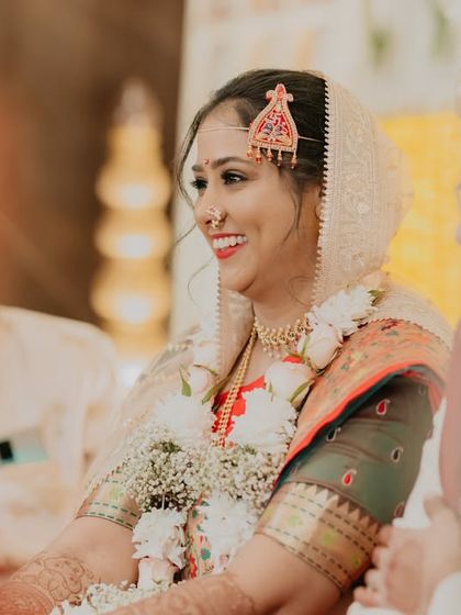 A beautiful, smiling bride captured candidly during her wedding ceremony. Her natural joy is what we aim to preserve.