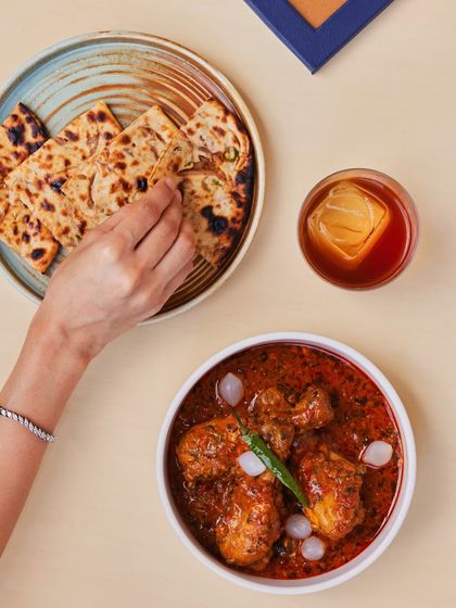 A hearty chicken curry served with our freshly made naan and a classic Old Fashioned. This combination showcases how our food and drinks menus are designed to complement each other perfectly.