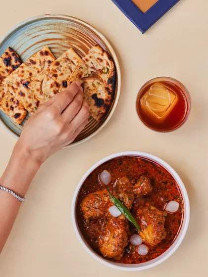 A hearty chicken curry served with our freshly made naan and a classic Old Fashioned. This combination showcases how our food and drinks menus are designed to complement each other perfectly.
