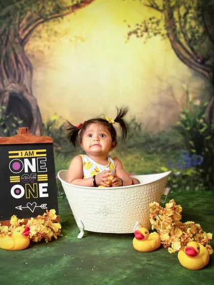 With her cute pigtails and thoughtful gaze, this little one is enjoying her special birthday bath. These sessions are all about capturing your child's personality in a fun setting.