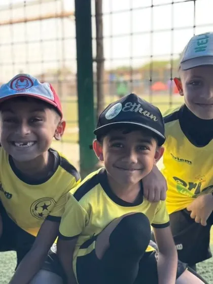 Three of our U-7 players, all smiles and ready to play. This is what loving the game looks like.