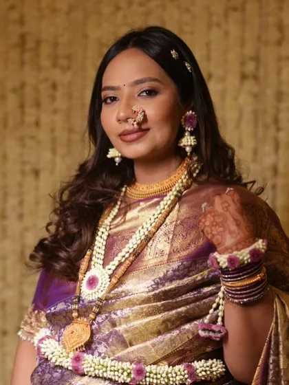 Glowing and gorgeous for her baby shower. This traditional look with a beautiful Paithani saree and floral jewelry is perfect for celebrating the little one on the way.