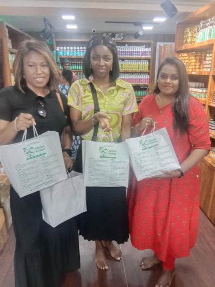 Three happy international customers proudly hold up their Lakshmi Krishna Naturals shopping bags. We are grateful for the global love and trust placed in our blend of Indian heritage and natural wellness.