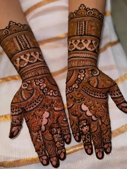 A lovely engagement mehendi with architectural and floral bands, showing a rich, fresh stain.