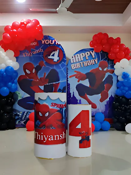 This Spiderman theme for a 4th birthday uses dual backdrops and themed pedestals to create an impressive display.