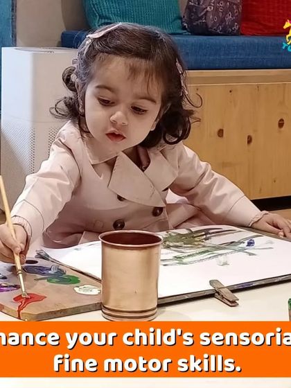 A toddler expresses her creativity with paint. I provide a safe and inspiring space for little ones to explore art, enhancing their sensory and fine motor skills.