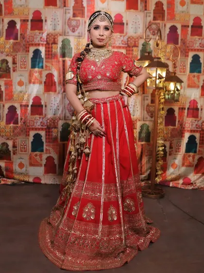 A full-length view of the bride against a festive backdrop. This image shows how the entire look, from the jewellery to the lehenga, comes together to create a picture-perfect moment.