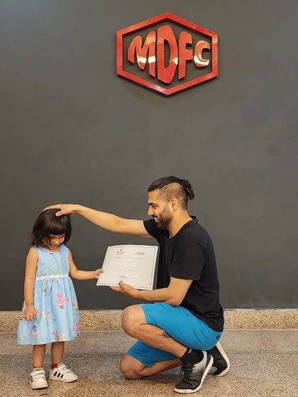A gentle moment of encouragement while presenting a certificate on International Dance Day.
