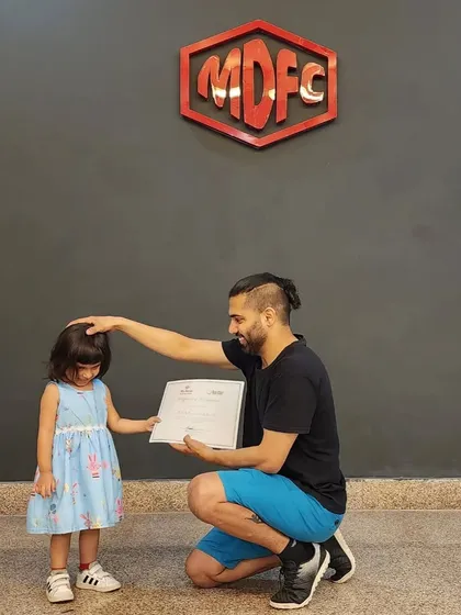 A gentle moment of encouragement while presenting a certificate on International Dance Day.
