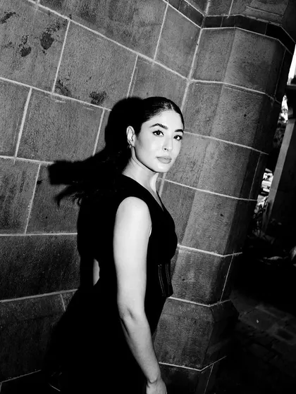A dramatic black and white shot of the Mamkam jumpsuit, highlighting its strong lines and architectural feel.