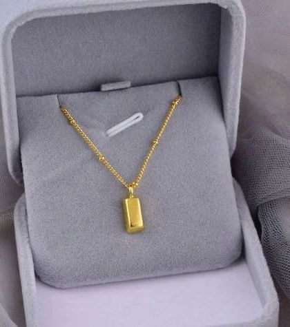 A simple yet chic gold bar pendant on a delicate beaded chain, presented in its gift box. This makes a perfect, elegant gift for someone special.
