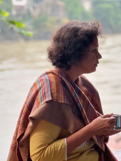 A participant enjoying a quiet cup of tea by the river. My retreats are designed to help you slow down and savor the present moment.