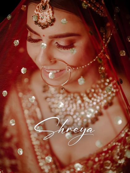 A close-up getting-ready portrait of the bride, Shreya, with confetti adding a magical touch.
