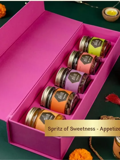 A pop of color can bring so much joy. This 'Spritz of Sweetness' hamper, with its vibrant pink box and an assortment of gourmet flavored nuts, is a perfect example of a modern and fun thank you gift that guests will love.
