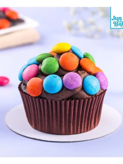 A childhood favorite in a cupcake! This chocolate cupcake is topped with colorful M&Ms, making it a fun and cheerful treat that's always a hit with kids and adults alike.