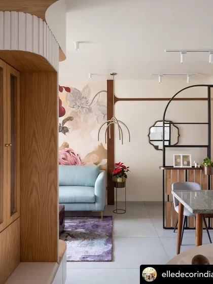 Another view of the 'Native Grace' mural in its living room setting, showing how it anchors the space and complements the surrounding furniture and decor with its soft, eclectic charm.