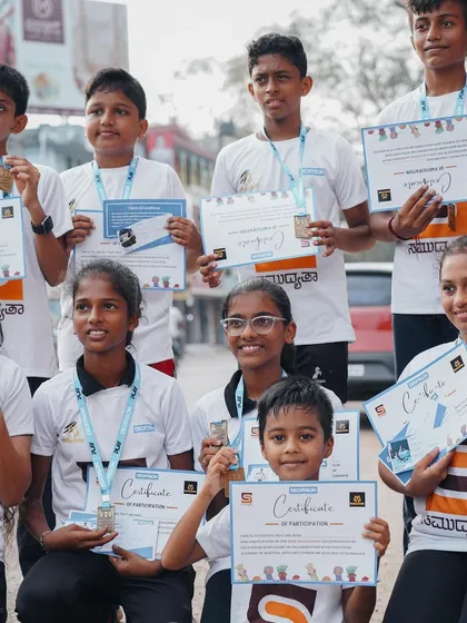 Every participant is a winner. Kids proudly show off their certificates and medals after completing the walkathon.