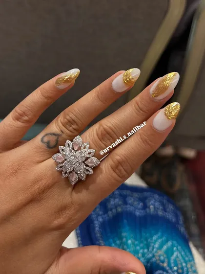 A striking design featuring a matte white base with textured gold chrome accents. The contrast between the simple white and the metallic gold creates a modern and luxurious look.
