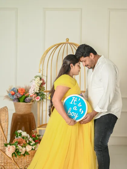 A tender moment during a gender reveal maternity shoot. The couple's gentle embrace shows their shared excitement and love.