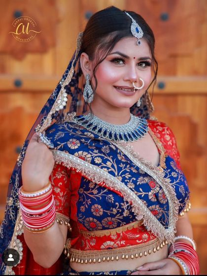 A bride in a traditional blue and red outfit, modernized with a sleek American Diamond choker. This shows how AD jewellery can be styled with ethnic wear.