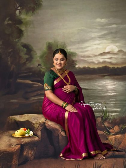 This seated portrait by a painted lake captures a moment of peaceful reflection and natural beauty.