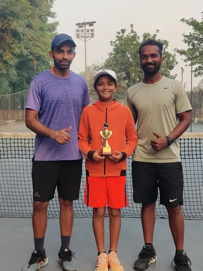Aarav Chhallani with his coach after finishing as Doubles Runner-up at the All India Super Series U-12 event in Jaipur. Teamwork and strategy are key.