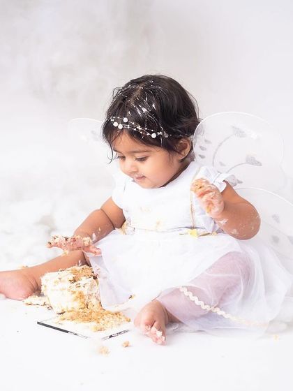 This little fairy is getting right into her cake. The excitement and mess are what make cake smash sessions so memorable and fun to look back on.