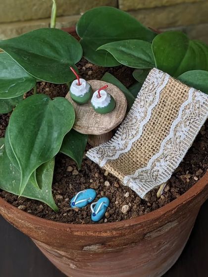 Cozy vibes with a miniature setup. This beach scene is a perfect escape, right in a planter pot.