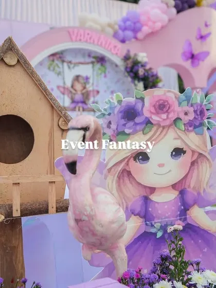 A detailed shot of the fairyland decor, including a birdhouse, a fairy cutout, and a pink flamingo.